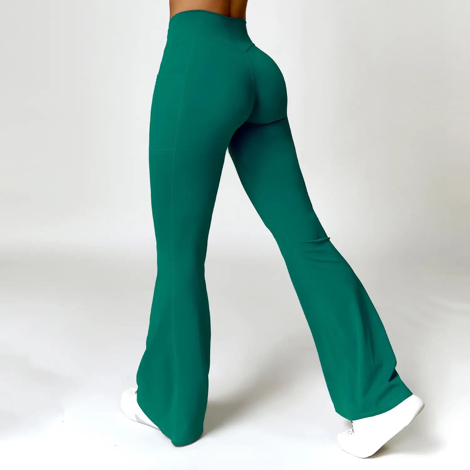emerald green high-waisted flared leggings made of smooth stretchy fabric featuring american hip raise design ideal for yoga and activewear.