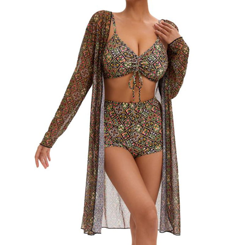 A woman wearing a digital printing pleated tie bikini with a matching long-sleeved cover-up featuring an intricate earth-toned geometric pattern in shades of brown green and gold.