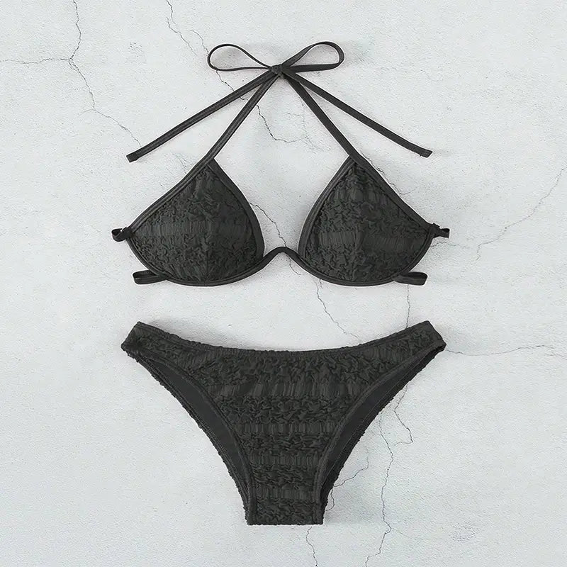 black lace two piece bikini split swimsuit featuring a halter style top and matching bottoms in a delicate lace material for a stylish bikini split look.