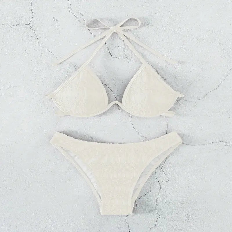 cream-colored lace bikini split swimsuit featuring a triangle top and matching bottoms with delicate tie-back straps