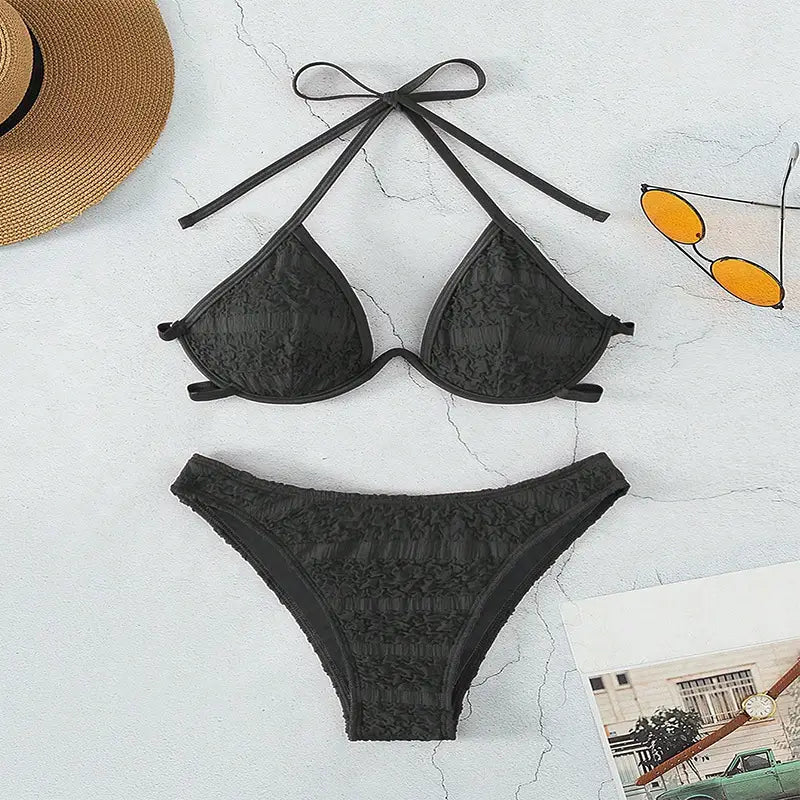 black lace two piece bikini split swimsuit featuring a lace triangle top with tied-back straps and a matching thong bottom in black lace material