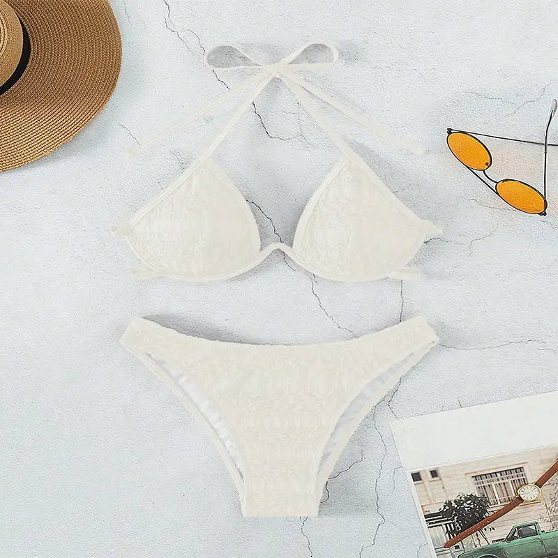 Off-white lace bikini split swimsuit featuring a halter top and high-waisted bottoms in a two piece split swimsuit design.