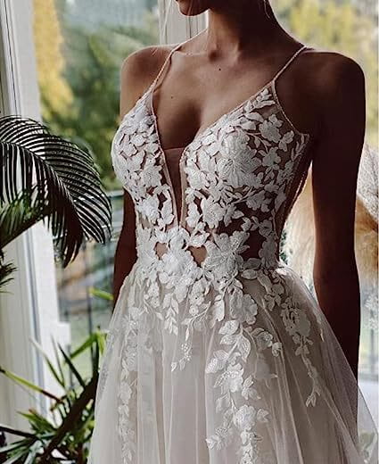 A white lace strap backless v neck wedding dress featuring delicate floral embroidery and a flowing tulle skirt showcasing elegant wedding dress lace details.
