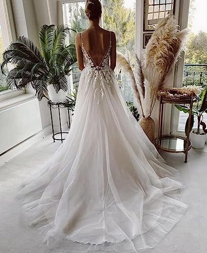 a flowing white wedding dress lace strap backless v neck design featuring delicate beading and lace detailing on the deep v-back visible from the back side