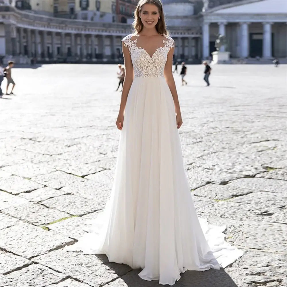 Elegant ivory v-neck a series chiffon wedding dress featuring intricate lace detailing on the bodice and lace sleeves with a flowing chiffon skirt.