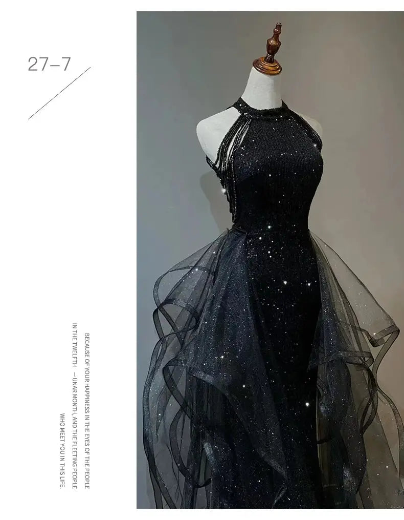 Black evening dress featuring a sequined halter bodice and a sheer layered tulle skirt perfect for evening occasions.