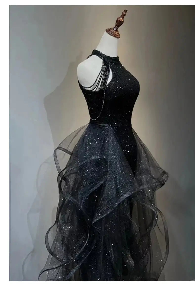 Black evening dress featuring a sequined halter top with a high neckline and a layered sheer tulle skirt ideal for formal evening occasions.