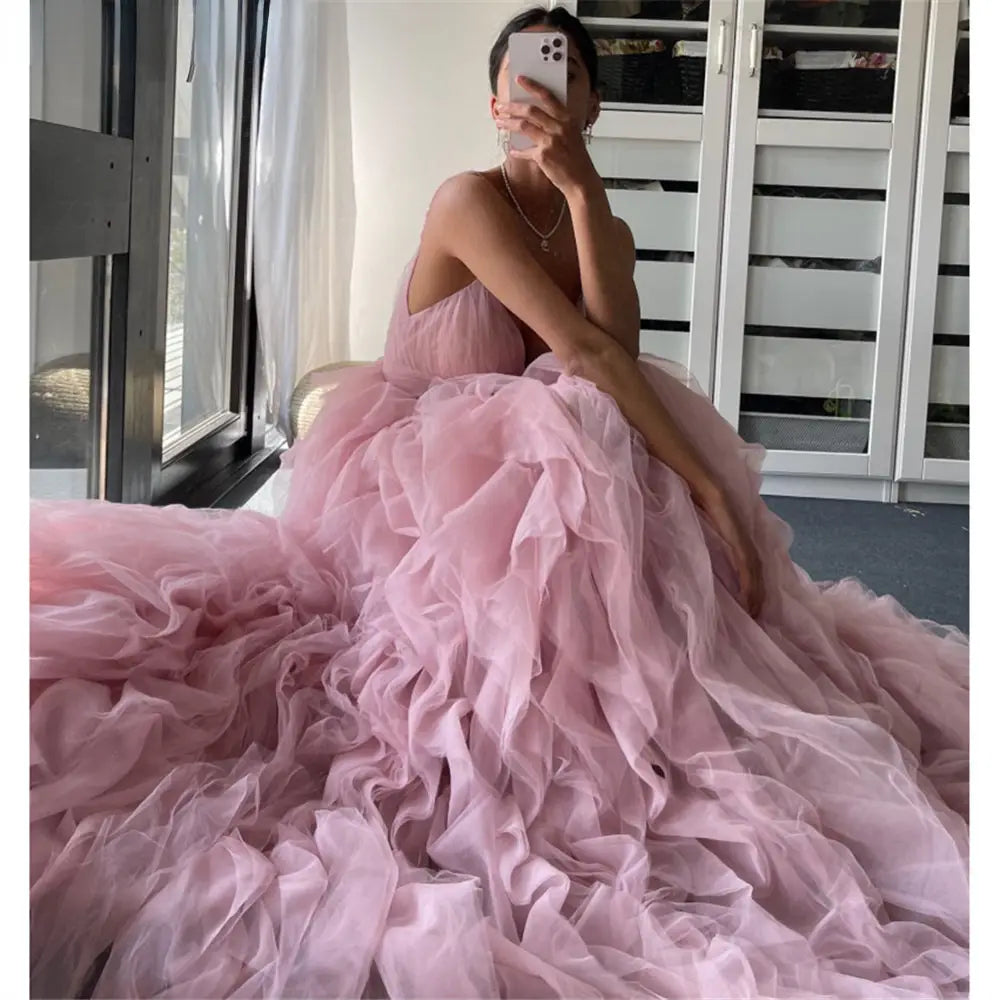 a flowing blush pink mesh long dress evening gown prom with a voluminous skirt and delicate ruffled layers designed as a gown prom irregular style