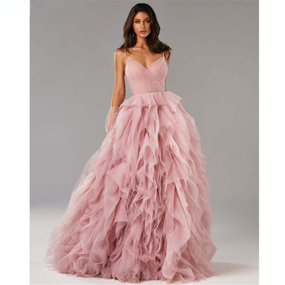 A flowing blush pink mesh long dress evening gown prom with a fitted bodice and layered ruffles featuring an irregular gown prom design.