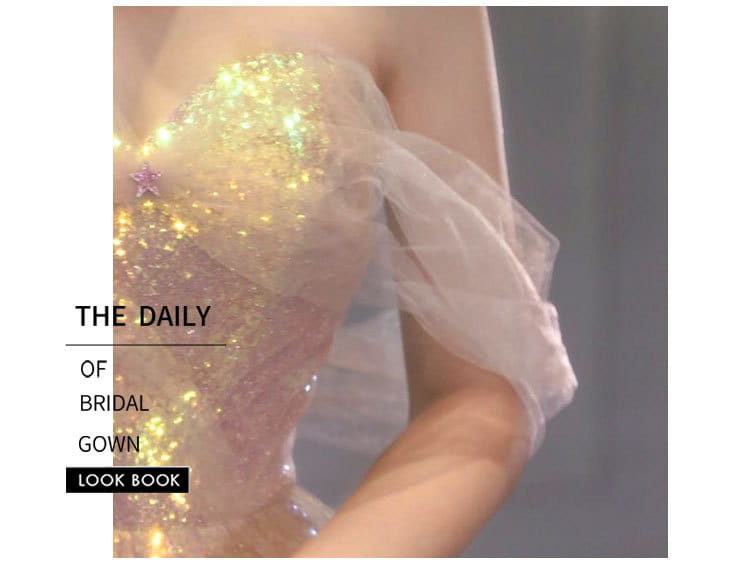 A shimmering gold sequined bodice with a delicate pink star pin and sheer white tulle overlay on a gradient mesh slimming annual party banquet mermaid dress.