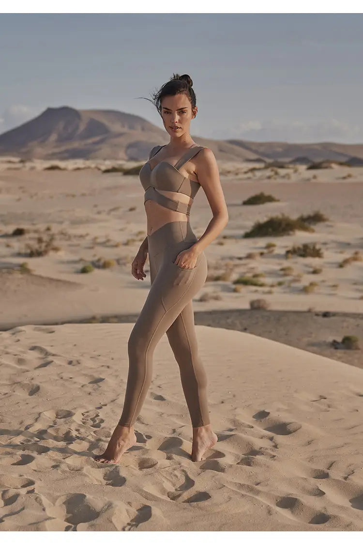 tan athletic two-piece set featuring a strappy bra top and high-waisted leggings paired with a beige yoga pants and sport coat fitness set in deep black color