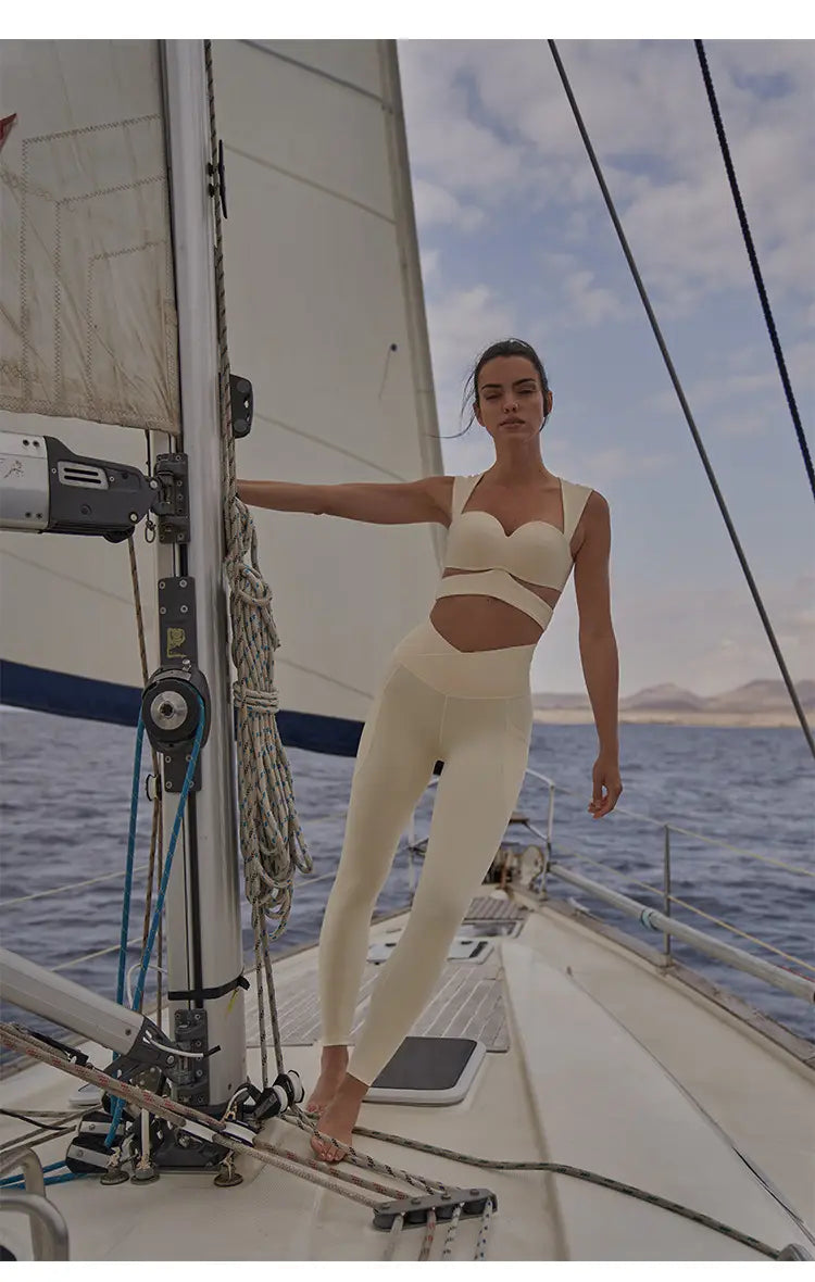cream-colored form-fitting athleisure set featuring a cropped top and high-waisted yoga pants in beige paired with a deep black color sport coat fitness set.