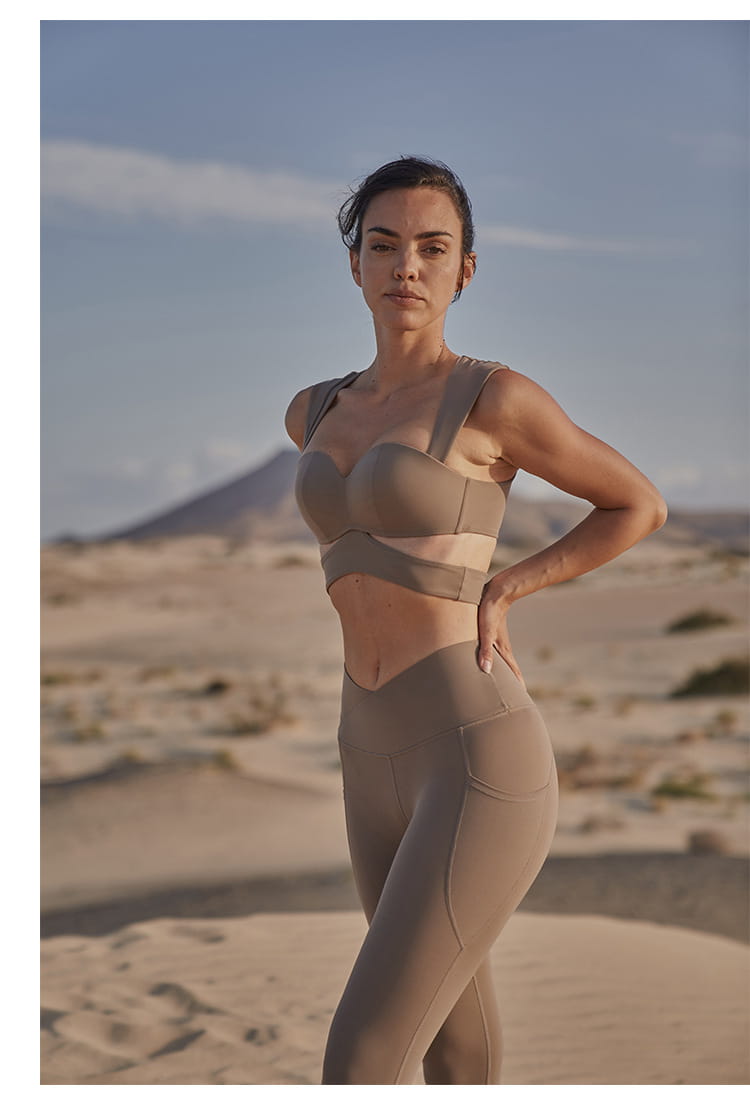 beige yoga pants and sport coat fitness set featuring a structured bra top and high-waisted leggings in a deep black color designed for athletic and casual wear.