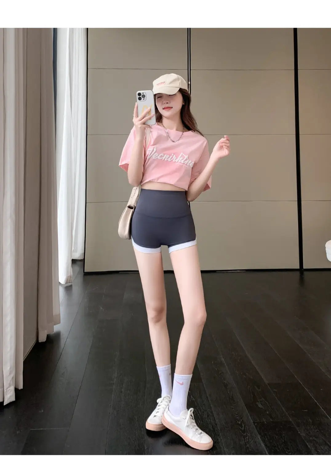 pink cropped t-shirt with white cursive lettering paired with brown high waisted hip lifting sports shorts designed for stitching yoga pants and hip lifting sports activities.