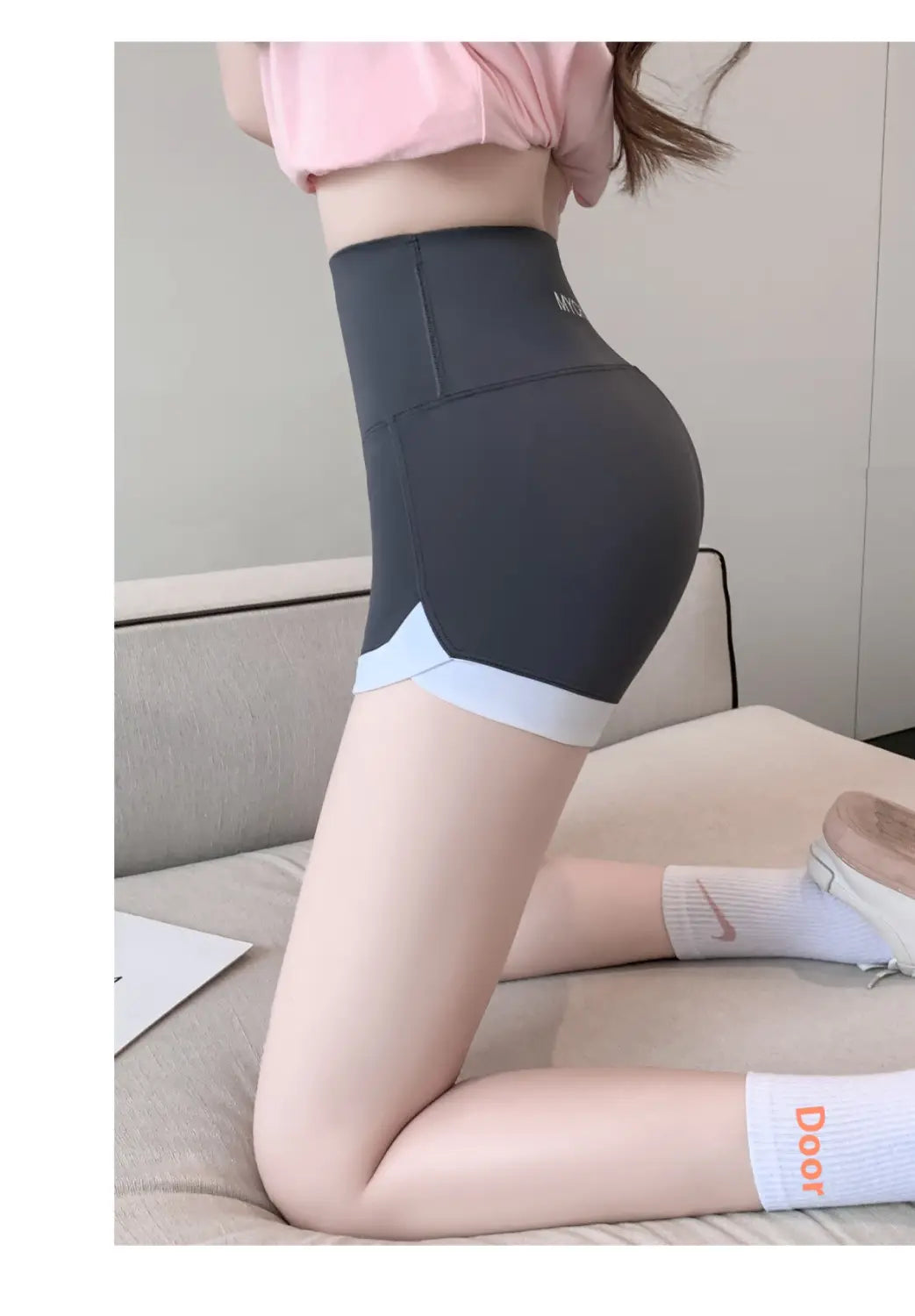 brown high waisted hip lifting sports shorts in dark gray with light blue trim designed for hip lifting and stitching yoga pants activities