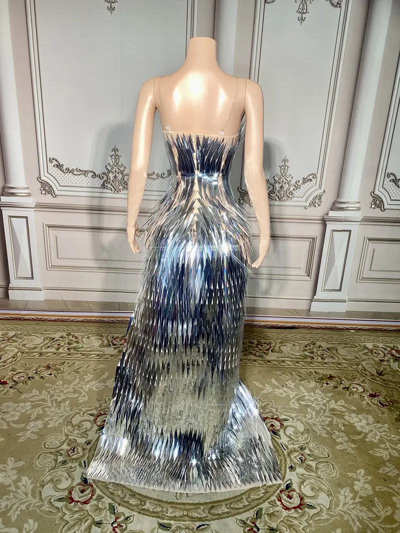 A silver metallic sequined evening dress with a structured corseted bodice and cascading pleated layers forming an elegant mermaid silhouette designed for stage advanced light luxury events.