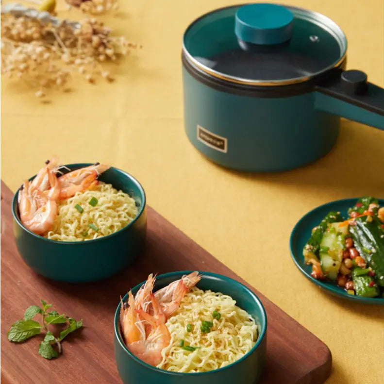 Teal compact multifunctional electric cooking pot with a matching lid and black handle featuring a sleek modern design for efficient electric cooking.