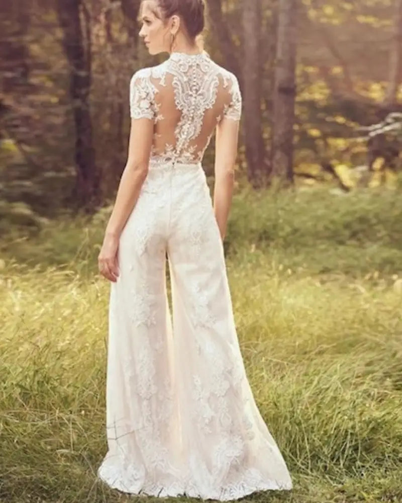 white lace bride pants suit with sheer back and floral embroidery for a suit wedding bridal look