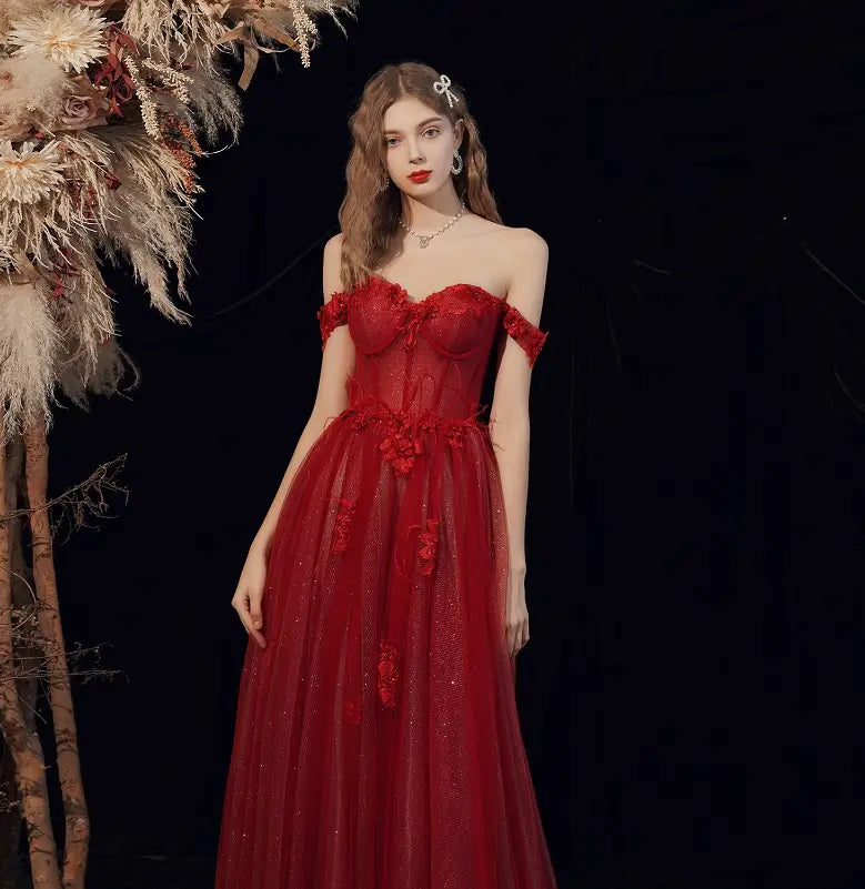 A striking red lace off shoulder wedding toast dress featuring intricate lace detailing and a flowing tulle skirt ideal for a toast dress host or dress host annual events.