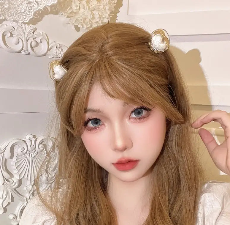 Delicate gold heart-shaped hair clips with pearl accents designed to complement diamond love pearl jewelry collections.