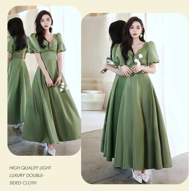 A flowing avocado green sisters group satin midi dress with puffed short sleeves a v-neckline and delicate lace detailing.