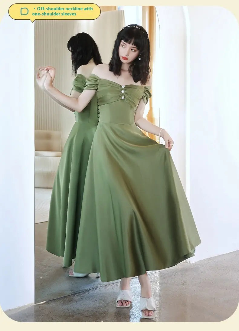 a flowing avocado green sisters group satin midi dress with an off-the-shoulder neckline and one-shoulder sleeves featuring a gathered bodice detail