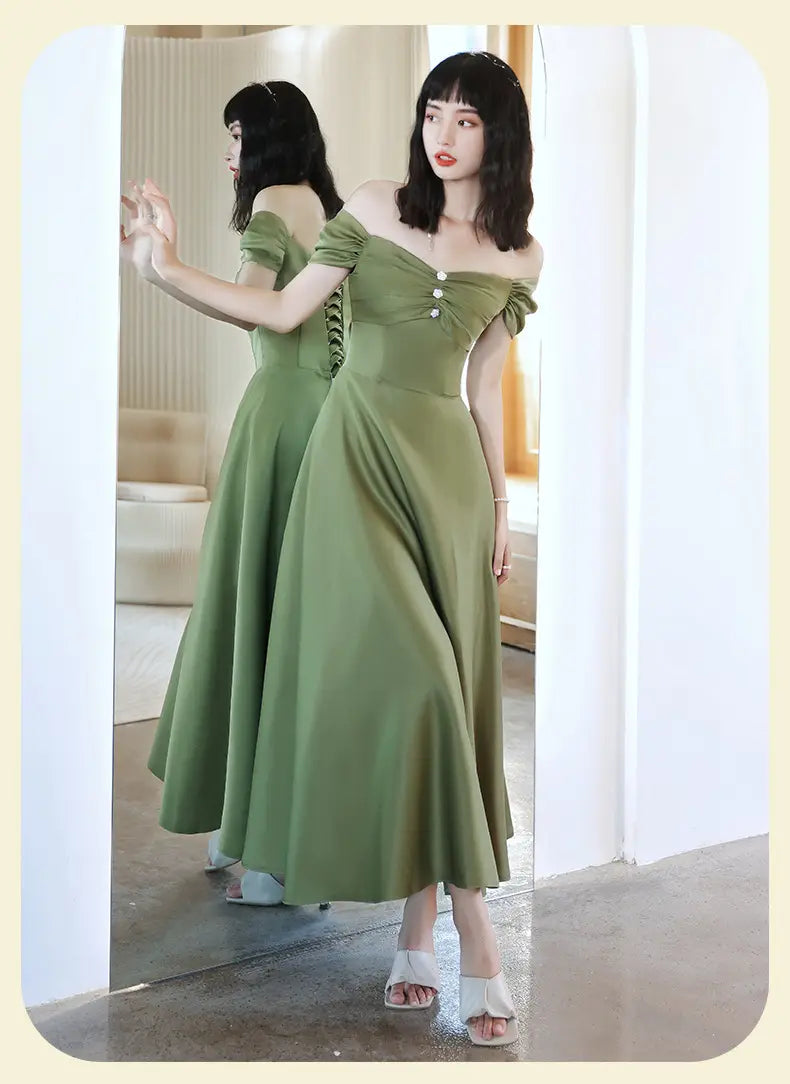 A flowing avocado green sisters group satin v neck midi dress features an off-the-shoulder design with a fitted bodice and delicate button detailing along the front.