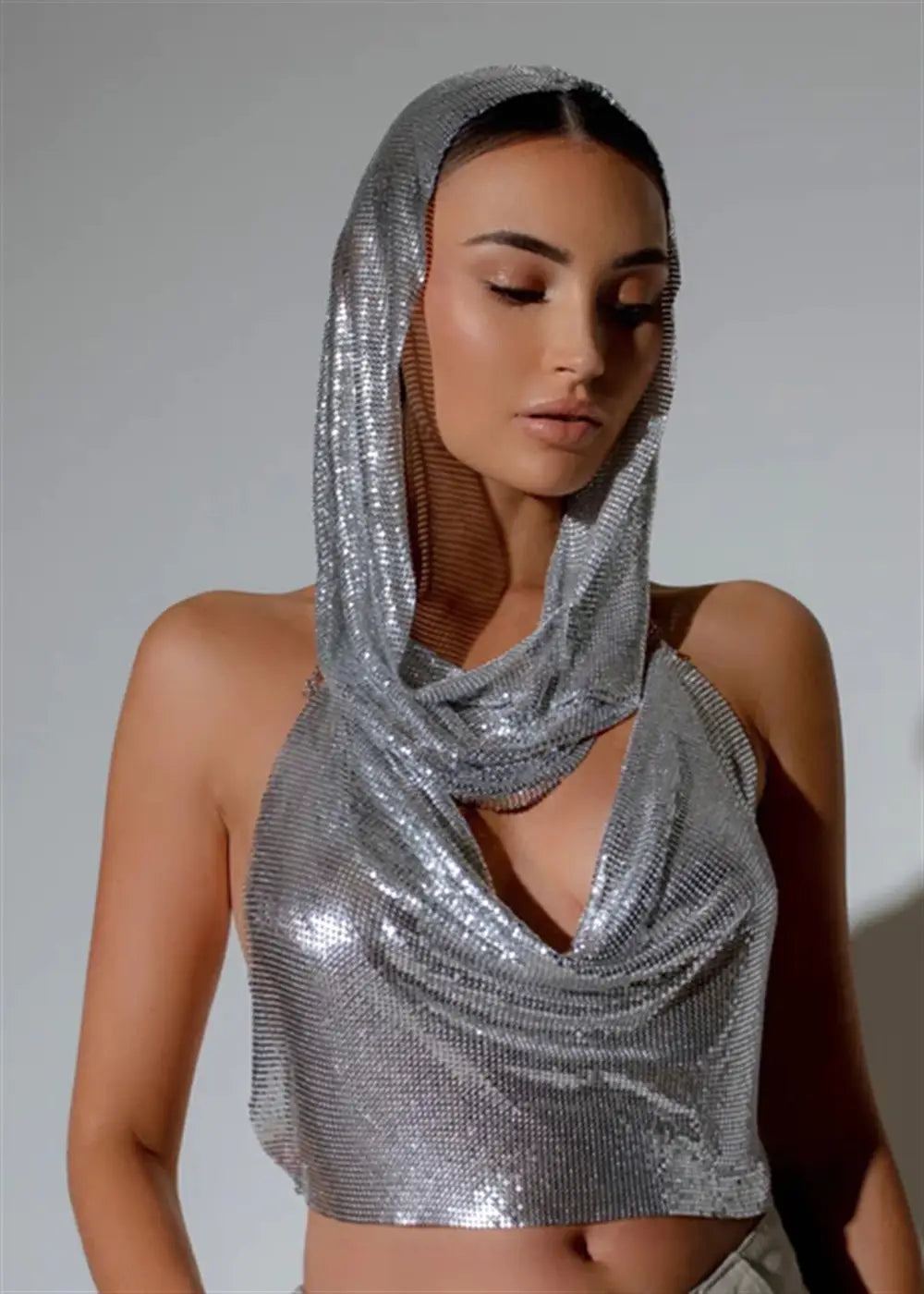 silver metallic mesh crop top with matching hood from a slit metal sequins two-piece set featuring a slit metal design