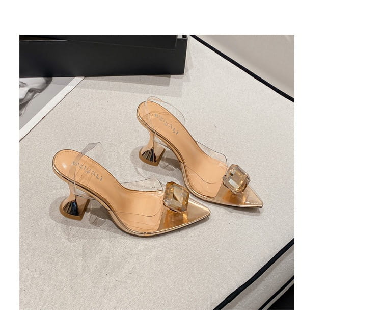 pink satin bow women’s high-heeled sandal in transparent crystal-encrusted mules with gold-toned heels and a sleek modern design.