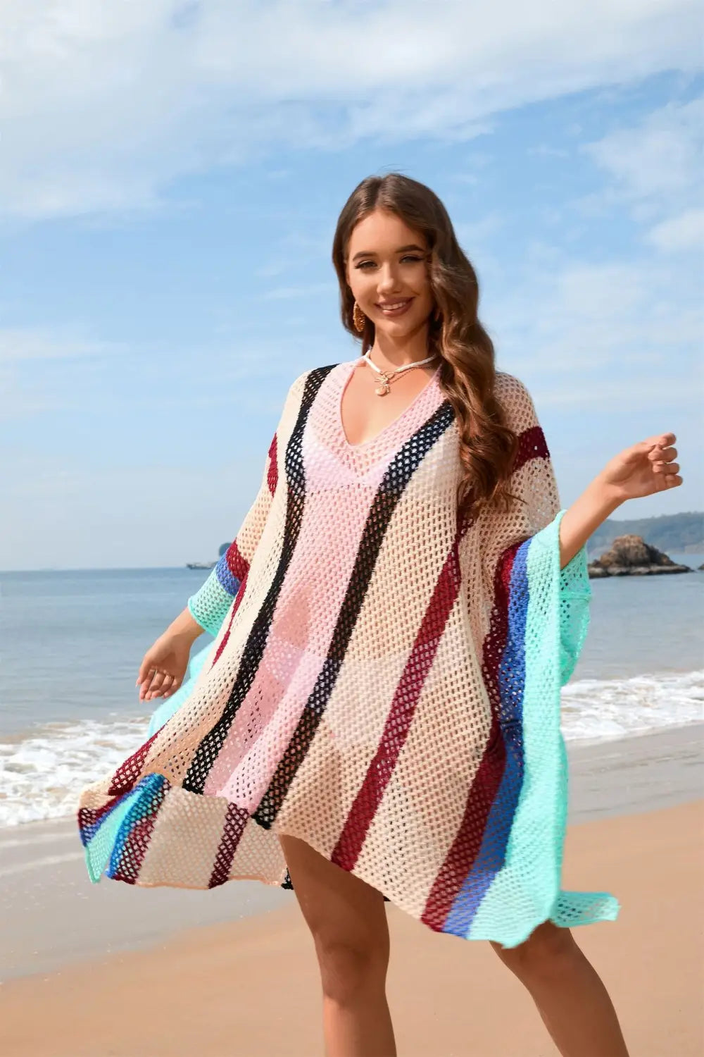 a colorful loose plus size bikini blouse featuring vertical stripes in pink black red and turquoise knitted as an open-front beach cover-up