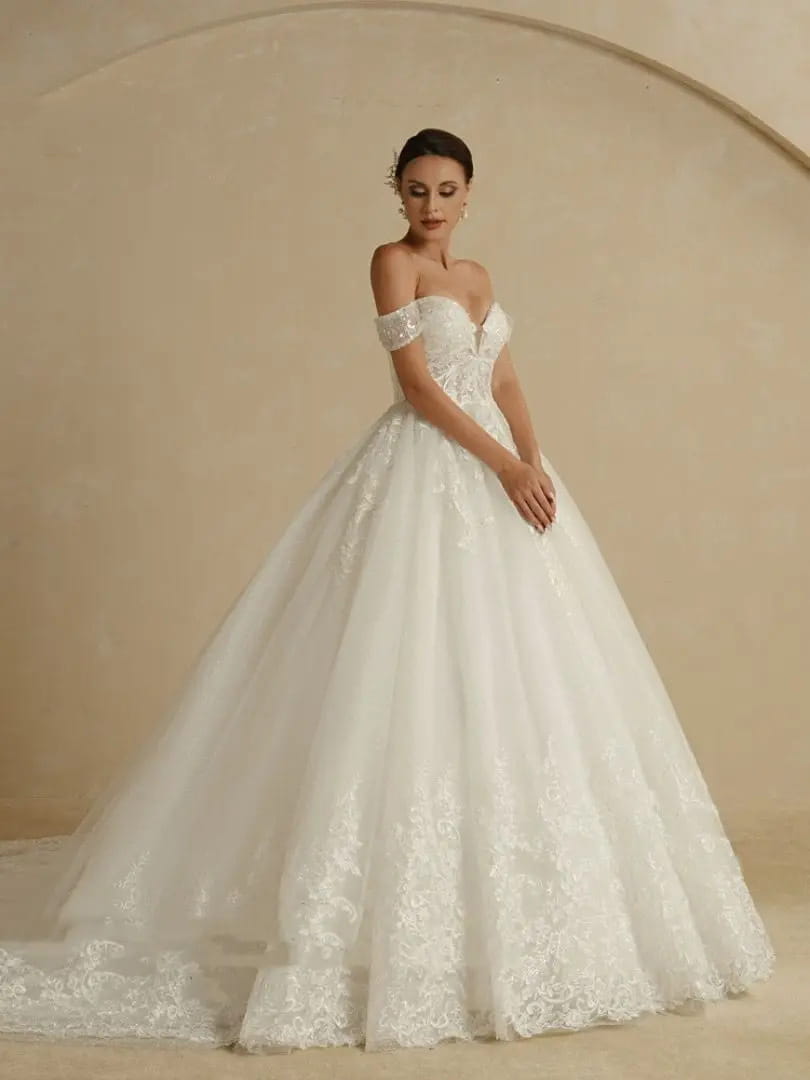 A white off-shoulder lace bridal main wedding dress with intricate lace detailing and a voluminous skirt.