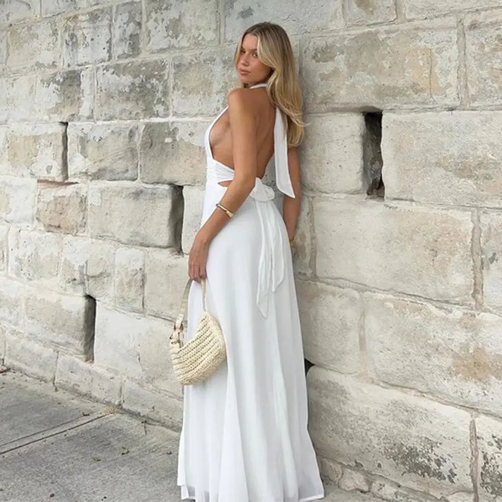 a flowing white halter-neck maxi slit dress summer with a back tie and cutout detail showcasing summer backless strappy design