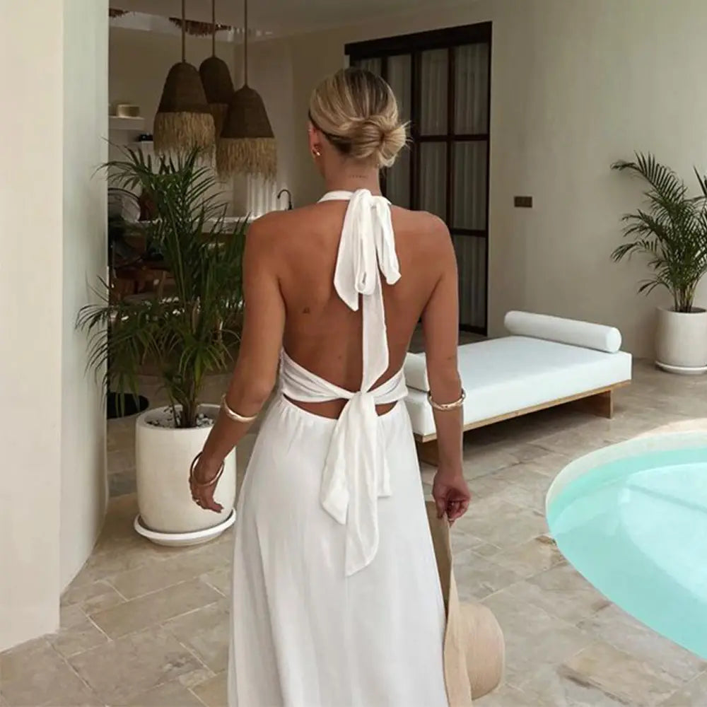 white backless maxi dress shown from the back with a flowing tie-back design, perfect as a summer backless strappy slit dress summer option