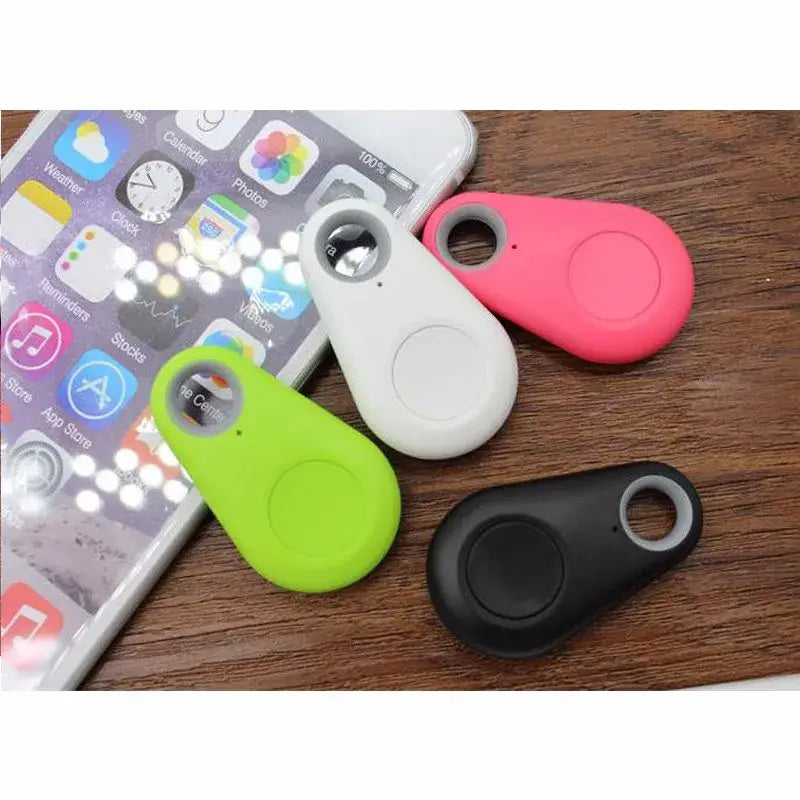 Colorful silicone Bluetooth anti lost object trackers in pink white green and black designed as water drop shapes for lost object finder use.