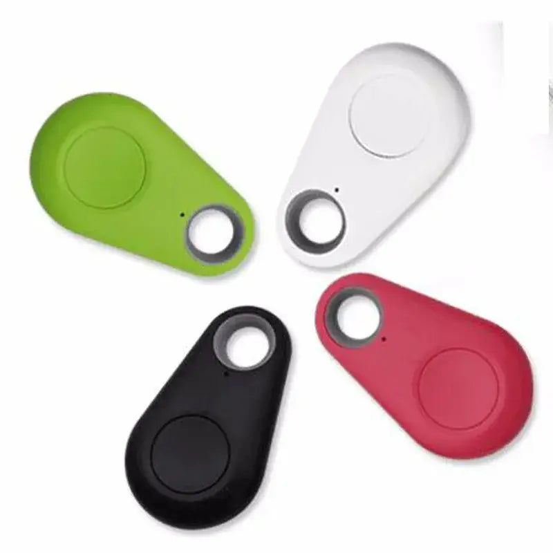 Four sleek teardrop-shaped black water drop anti lost object bluetooth trackers in vibrant green white black and red for use as a lost object finder.