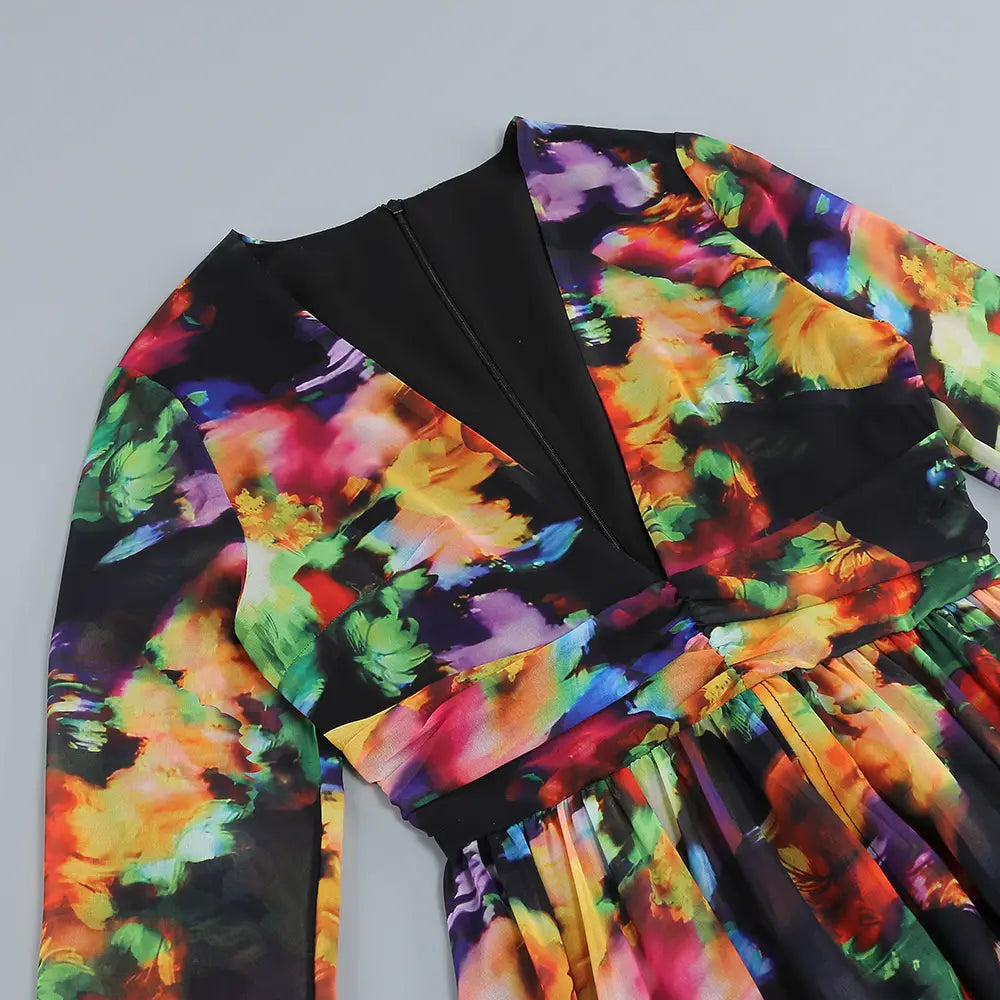 A vibrant long-sleeved casual dress with a bold rainbow floral print on black fabric featuring a v-neck split comfort design.