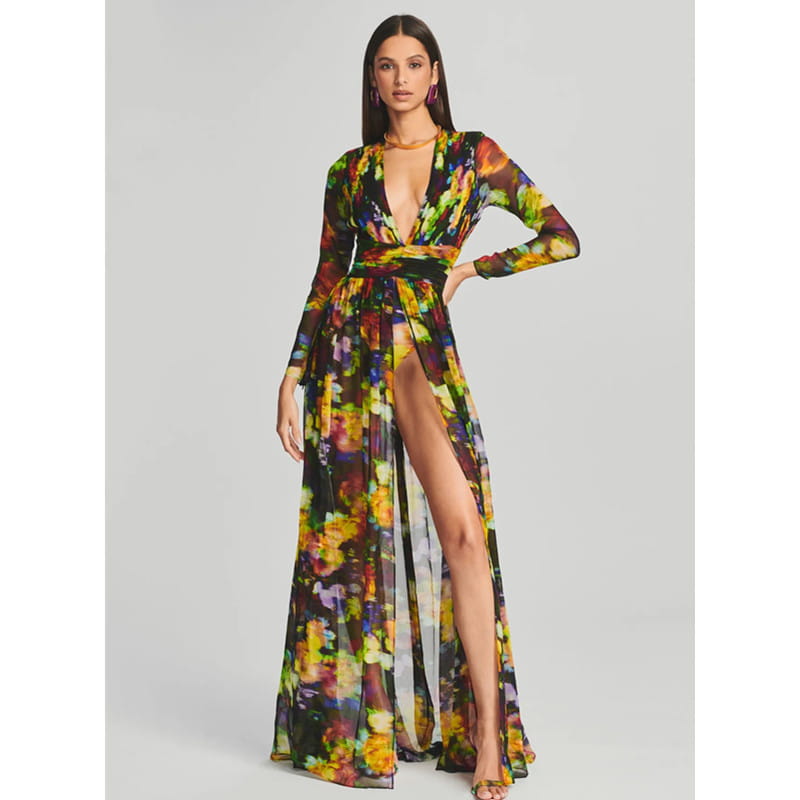 A vibrant long-sleeved floral v-neck split comfort casual dress with an abstract floral print in yellow green purple and orange on a dark base fabric.