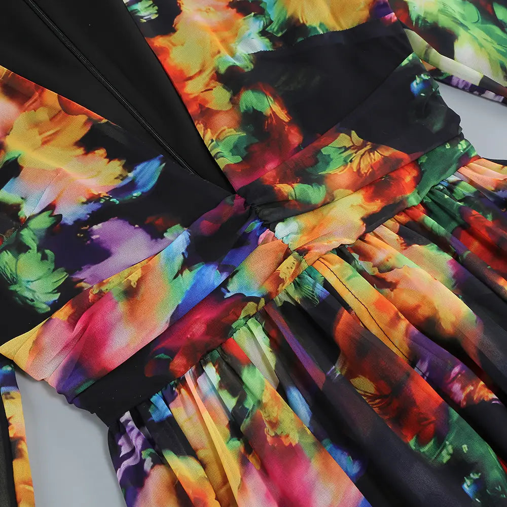A vibrant multicolored floral casual dress with a black base, v-neck split comfort design, and ruffled skirt.