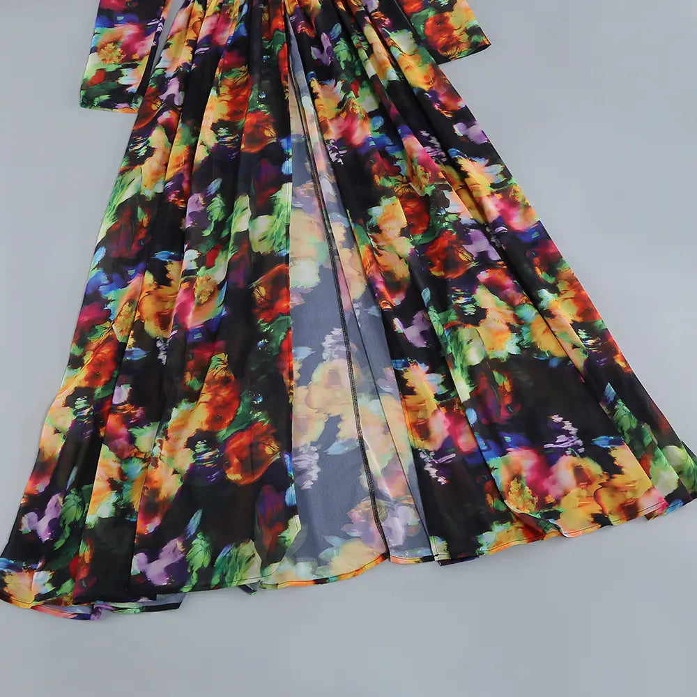 A flowing long-sleeved maxi casual dress with a vibrant floral print on black fabric featuring a v-neck split comfort design.