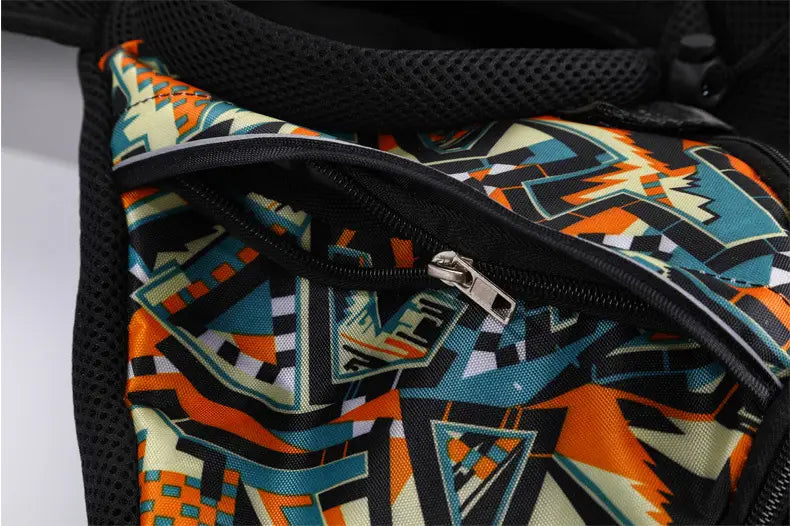 a vibrant geometric-patterned fanny pack with bold orange teal and black abstract designs displayed on a fabric surface as part of a black mesh carrying pets bag for women designed for outdoor use.