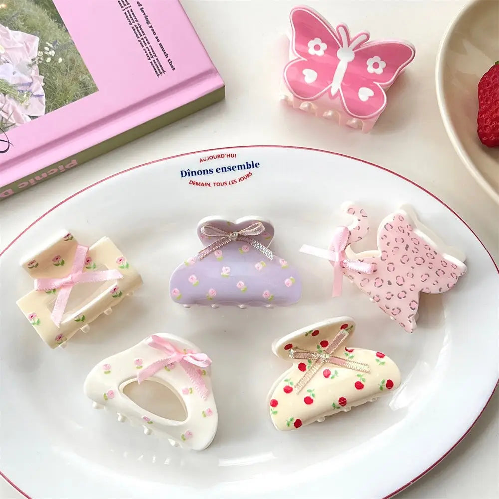 Pastel purple small jaw clip with floral pattern and delicate pink ribbon bow designed as a pink butterfly floral small jaw clip with bow.