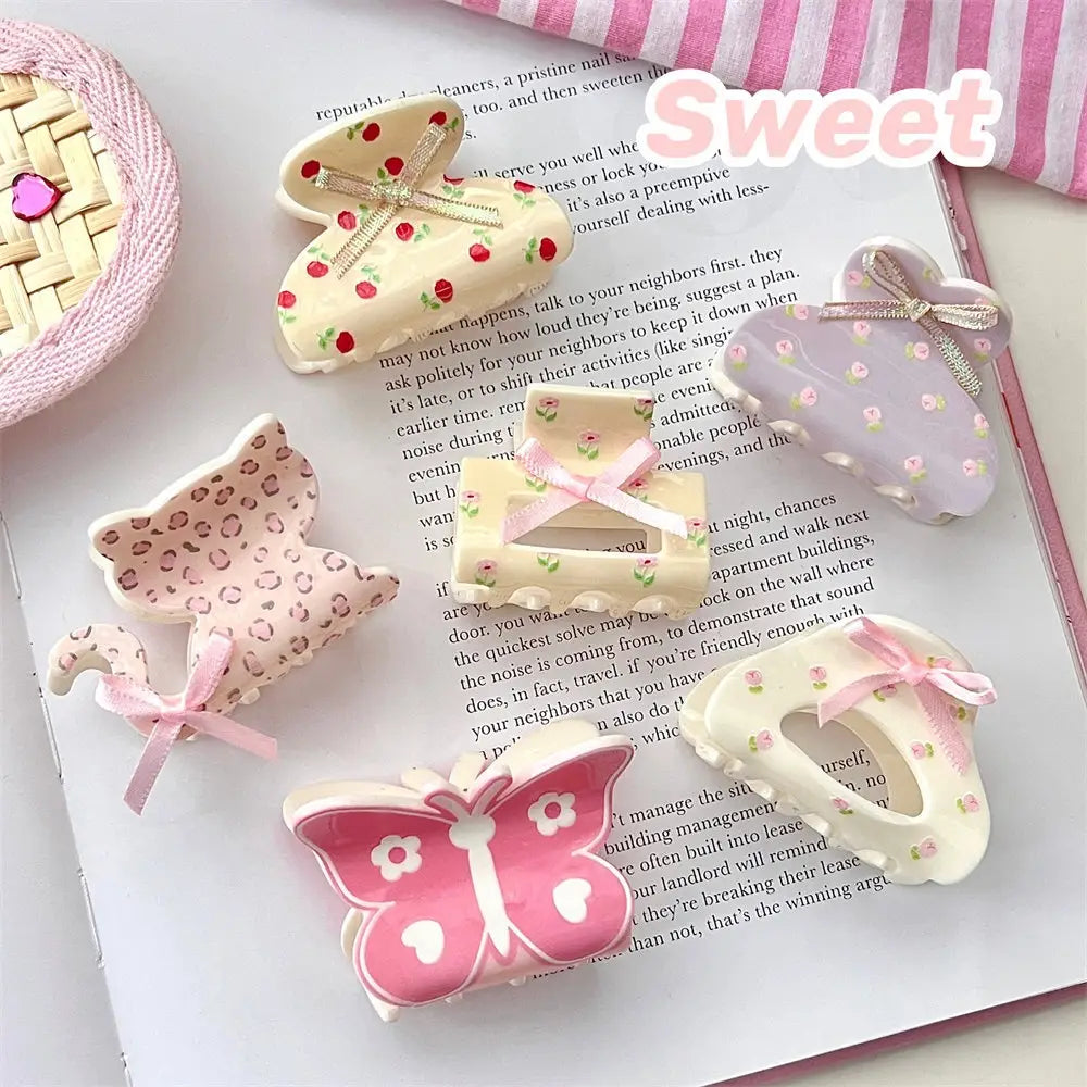 Pastel-colored pink butterfly floral small jaw clip with delicate leopard print patterns and tiny bows featuring a secure jaw clip grip.