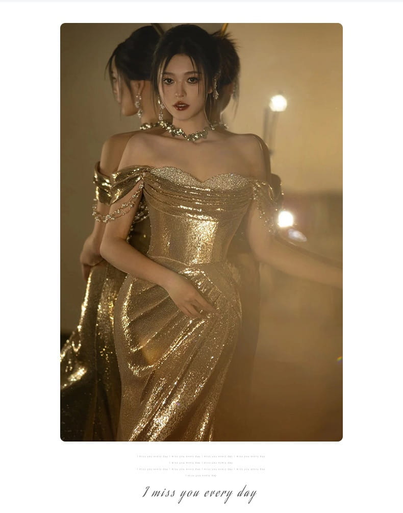 A shimmering gold sequined off-shoulder dress bridal fishtail gown with a fitted bodice and flowing skirt perfect as a gold evening dress or toast dress bridal.