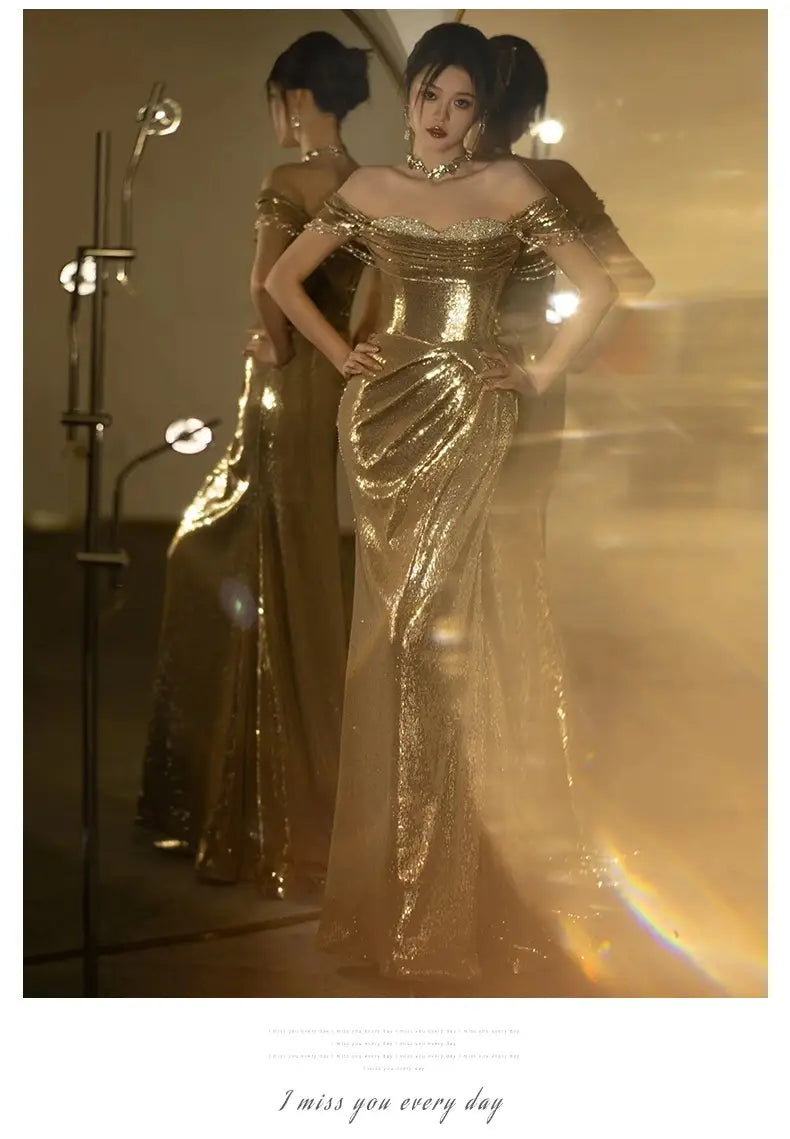 a shimmering gold sequined off-shoulder dress bridal fishtail gown with a fitted bodice and flowing skirt perfect for a toast dress bridal or gold evening dress occasion