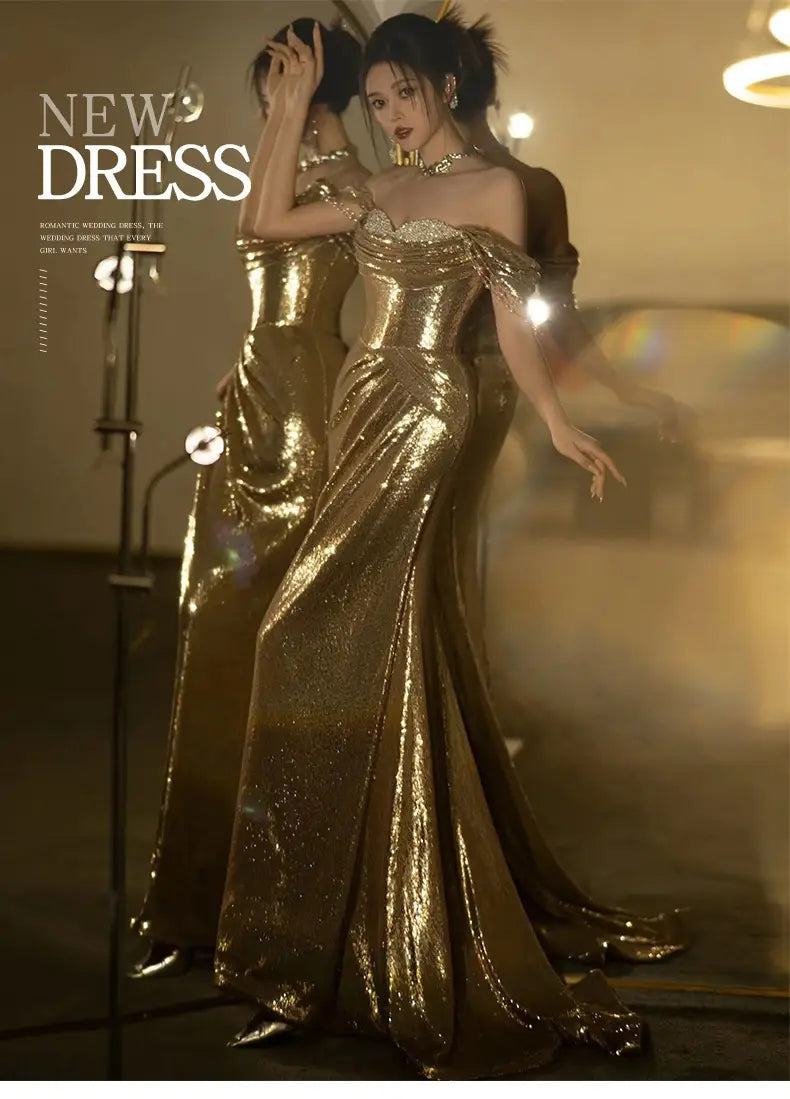 A shimmering gold sequined off-shoulder dress bridal fishtail gown with a fitted bodice perfect as a gold evening dress or toast dress bridal.