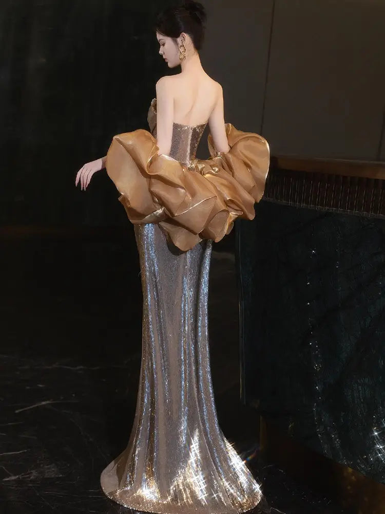 A gold sequined banquet temperament evening dress featuring a shimmering silver sequined gown with a dramatic gold satin ruched bodice and voluminous sleeves.