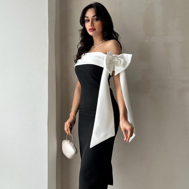 off-shoulder color matching elegant cocktail dress in black and white featuring a large satin bow on the shoulder for a matching elegant cocktail look