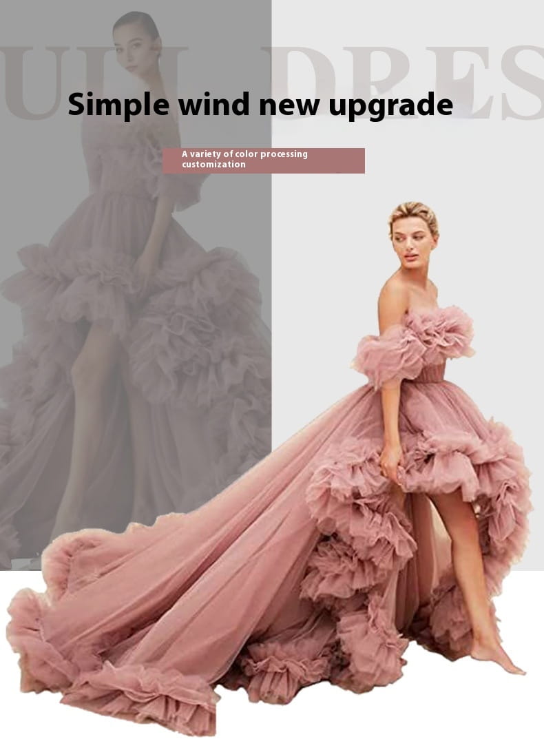 a luxury women’s fashion high low gown in blush pink tulle featuring layered ruffles and an off-the-shoulder design suitable as a beaded evening gown alternative