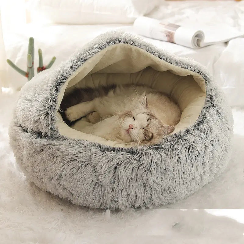 soft gray round plush warm cat bed pet with a cozy beige interior and fluffy exterior designed for comfortable rest.