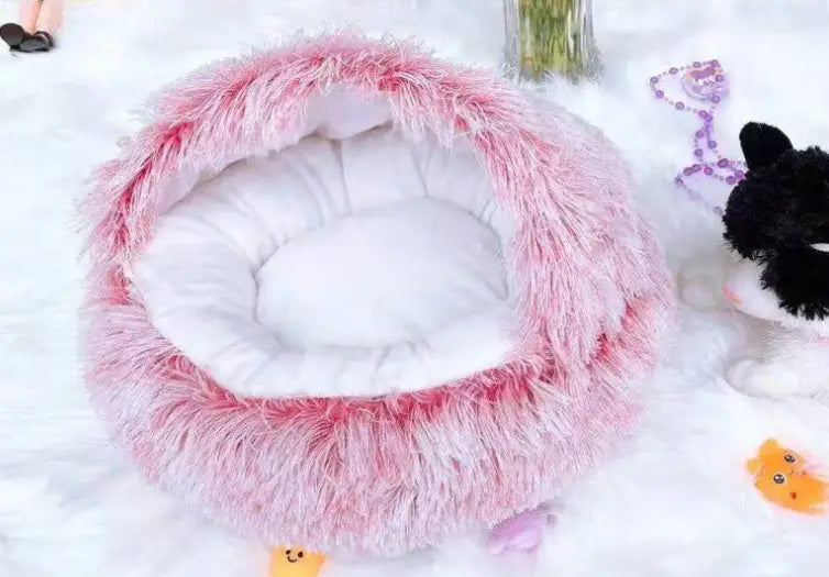 pink round plush warm cat bed pet featuring a fluffy exterior and white cushioned interior for comfortable rest